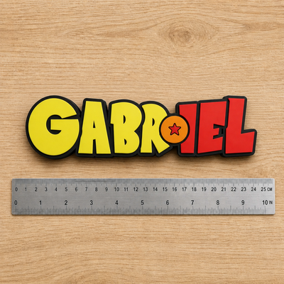 Personalized Dragon Ball Z-inspired GABRIEL nameplate beside a dual-scale ruler showing approximately 23 cm (9 in) width