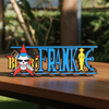 Personalized one piece nameplate with the Franky jolly roger on a wooden table