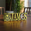 Personalized one piece nameplate with the Law jolly roger on a wooden table