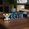 Personalized one piece nameplate with the Pirate Crew jolly roger on a wooden table