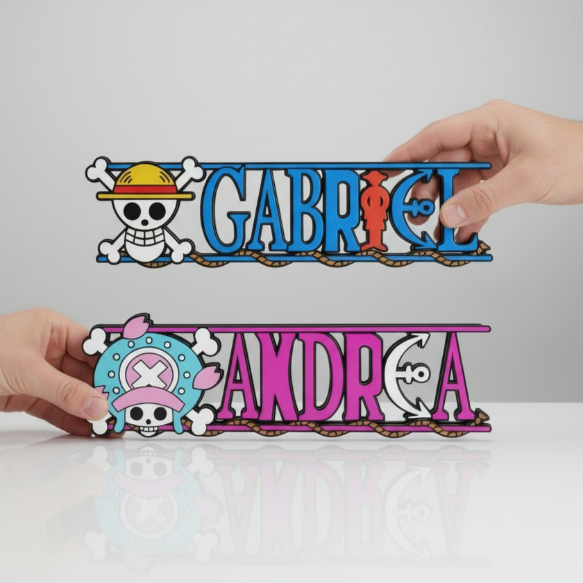Two hands each holding a personalized one piece nameplate featuring luffy and chopper jolly rogers