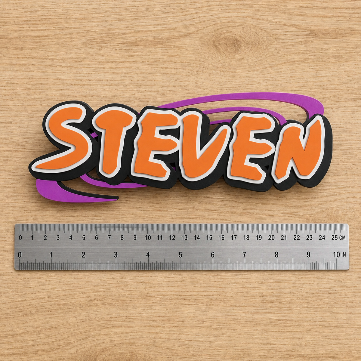 Personalized Naruto-inspired STEVEN nameplate beside a dual-scale ruler showing approximately 23 cm (9 in) width