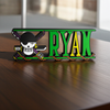 Personalized one piece nameplate with the Zoro jolly roger on a wooden table